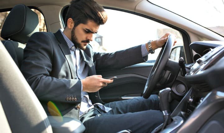 man texting in car man texting in car