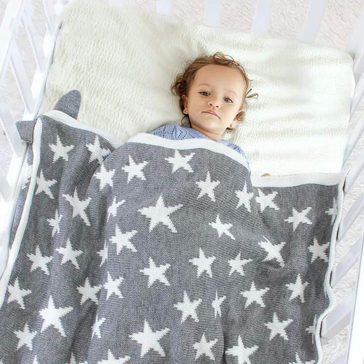 an image of a baby sleeping in a 30x40 blanket 