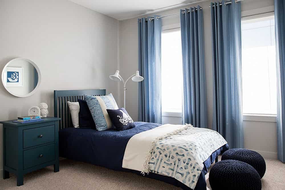 an image of Small modern beach style blue bedroom with blue curtains