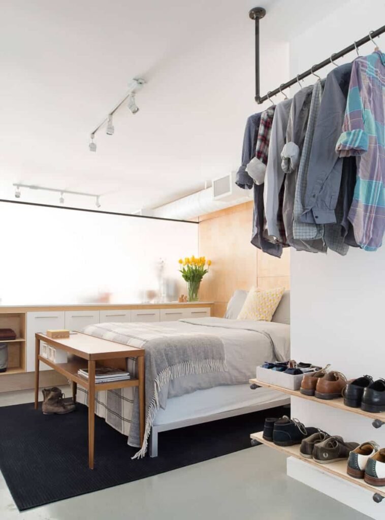 hanging clothing rack in a mens bedroom