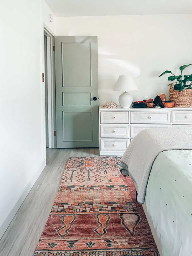 a long rug in a white bedroom
