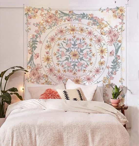 an image of a white bedroom with masculine vibes and a tapestry on wall
