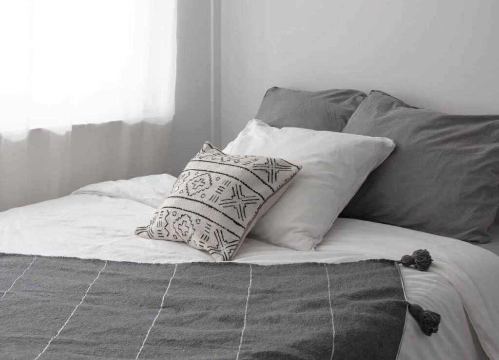 throw pillows on a beautiful grey bedroom
